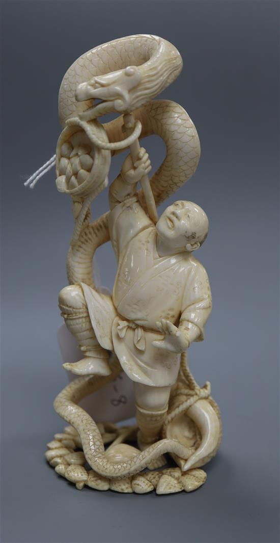 A Japanese ivory okimono of a fisherman and a sea snake, Meiji period height 15cm